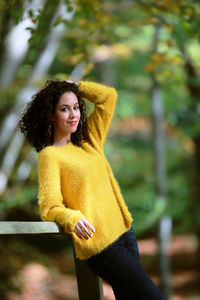 Portrait of young woman standing in park