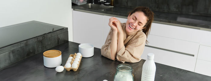 Side view of woman sitting on table