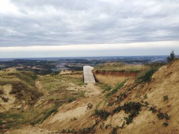 Scenic view of landscape against cloudy sky