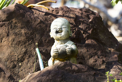 Old figurine on rock