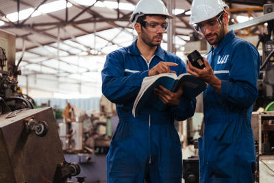 Portrait of young man working in factory