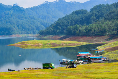 Scenic view of lake and trees against mountains