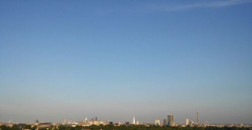 View of cityscape against blue sky