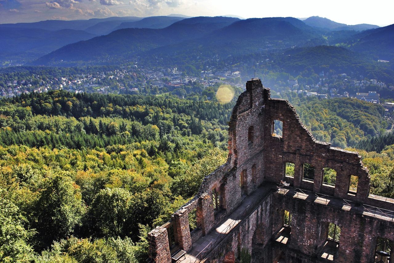 architecture, built structure, mountain, building exterior, tree, high angle view, mountain range, landscape, travel destinations, history, green color, nature, scenics, outdoors, famous place, day, tourism, growth, tranquility, house