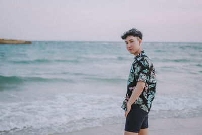 Man standing on beach against sky