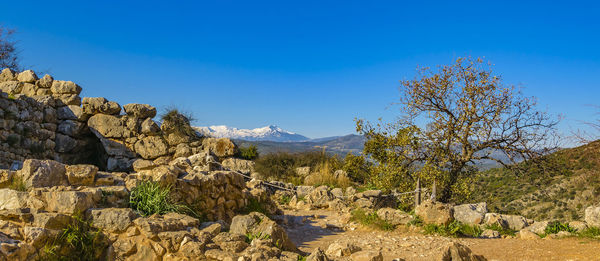 Scenic view of mountain against blue sky