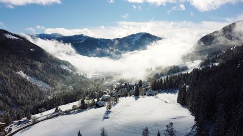 Scenic view of snow covered mountains against sky