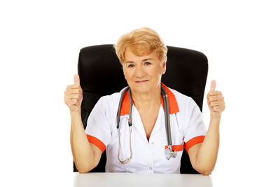 Portrait of woman standing against white background
