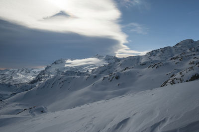 Scenic view of snowcapped mountains against sky