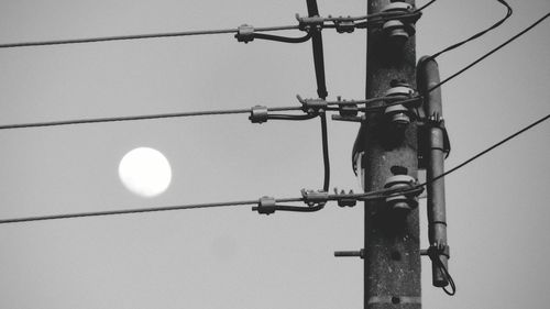 Low angle view of electricity pylon against sky