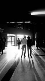 Rear view of people walking in subway station