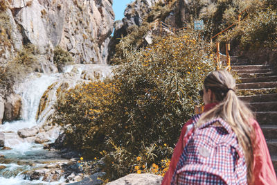 Young tourist walks on a path to the mountain. adventure travel, hiking concept.