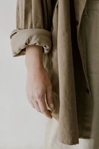 Midsection of man and woman standing against white background