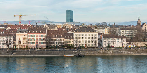 Buildings in city against cloudy sky