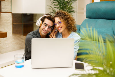 Young woman using laptop at home