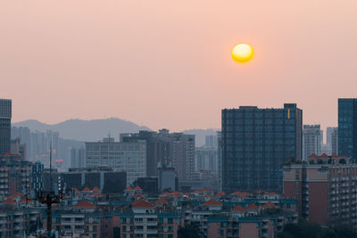 Cityscape against clear sky during sunset