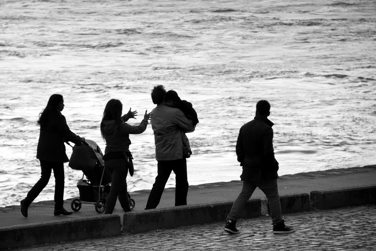 water, sea, togetherness, lifestyles, leisure activity, men, bonding, boys, love, full length, vacations, family, friendship, childhood, person, rear view, beach, girls