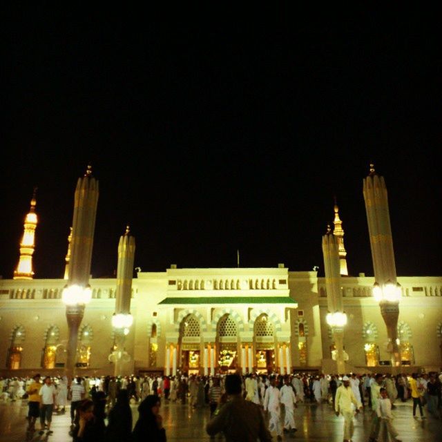 large group of people, night, architecture, built structure, illuminated, building exterior, men, crowd, clear sky, person, copy space, famous place, lifestyles, travel destinations, tourism, city, leisure activity, tourist, international landmark