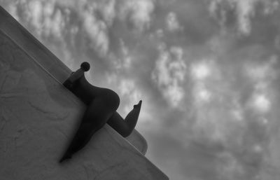 Low angle view of silhouette hand against sky