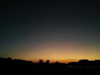 Silhouette of trees against sky at sunset