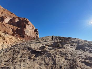 Rock formations on mountain against clear blue sky