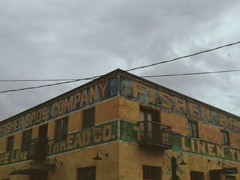 Low angle view of building against cloudy sky