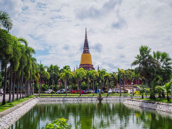 Panoramic view of lake amidst trees and buildings against sky