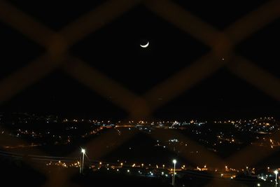 Illuminated cityscape against sky at night