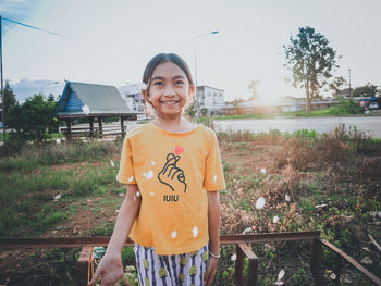 Portrait of smiling young woman standing outdoors