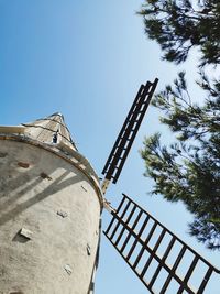 Low angle view of traditional windmill against clear sky