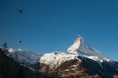 Scenic view of snowcapped mountains against clear sky