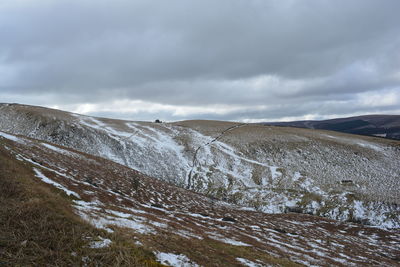 Scenic view of snow covered mountains against sky