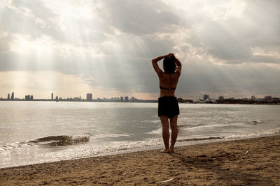 Silhouette of woman standing on beach