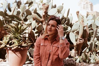 Woman looking away against plants