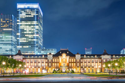 Illuminated buildings against sky at night