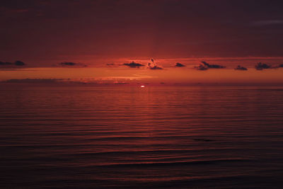 Scenic view of sea against orange sky