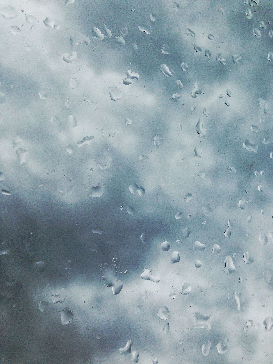 wet, drop, water, rain, window, full frame, weather, glass - material, transparent, backgrounds, raindrop, season, indoors, sky, glass, close-up, day, no people, monsoon, cloud - sky