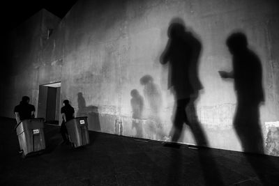 Silhouette people standing on floor