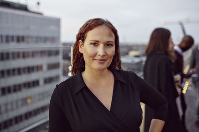 Portrait of confident businesswoman standing on terrace