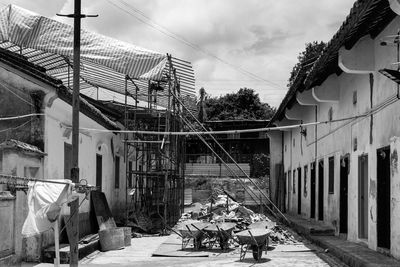 People on street amidst buildings against sky