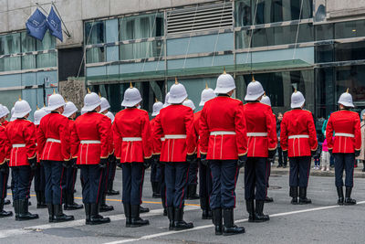 Rear view of platoon standing against building