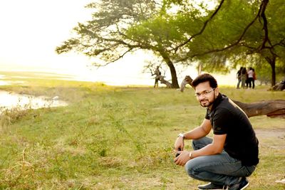 Young man sitting on field