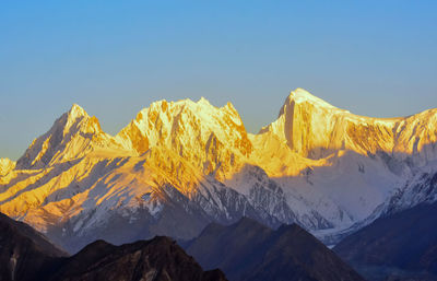 Scenic view of snowcapped mountains against clear sky