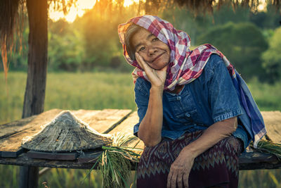 Portrait of smiling woman sitting in gazebo