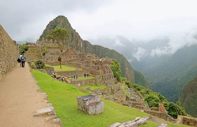 Amazing ancient inca ruins of machu picchu fortress with many of visitors, peru