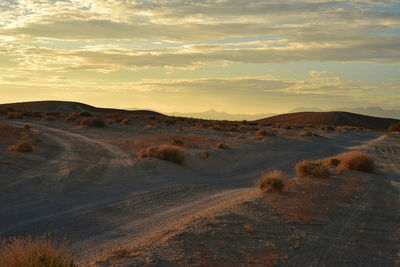 Scenic view of desert against sky during sunset