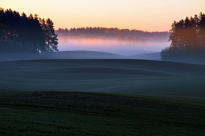 Scenic view of field against sky during sunset