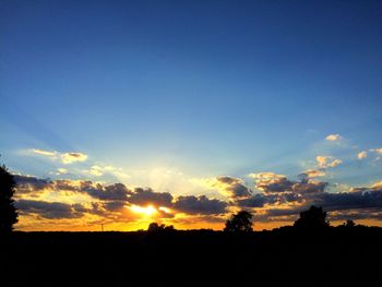 Silhouette landscape against sky during sunset