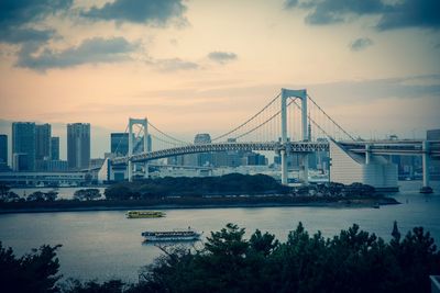 Bridge over river with city in background