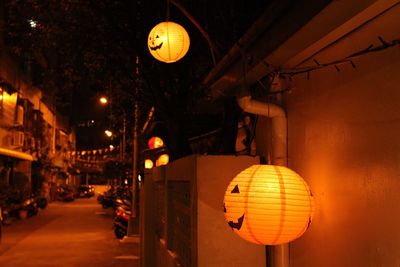 Illuminated lanterns hanging in city at night